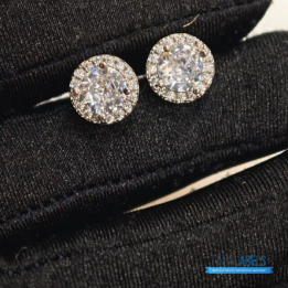 Tiffany & Co. Sterling Silver Moissanite Stud Earrings featuring a classic halo design.