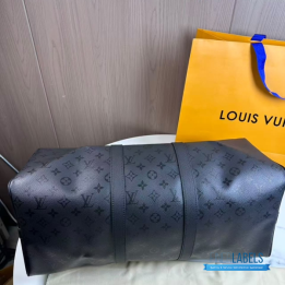 QC LV Keepall Bandoulière travel bag featuring a tone-on-tone Monogram canvas