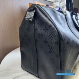 QC LV Keepall Bandoulière travel bag featuring a tone-on-tone Monogram canvas