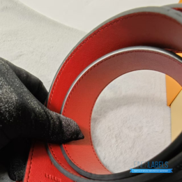 QC Louis Vuitton Reversible Belt featuring a textured black strap and red lining