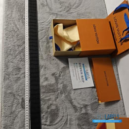 QC Louis Vuitton Reversible Belt featuring a textured black strap and red lining