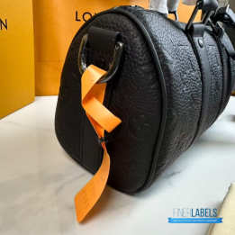 QC LV Keepall Bandoulière 25 crafted in black embossed monogram leather with matching dark hardware
