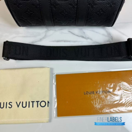 QC LV Keepall Bandoulière 25 crafted in black embossed monogram leather with matching dark hardware